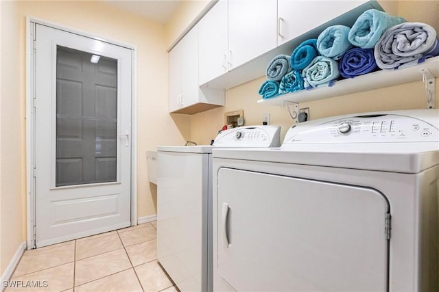 laundry room with cabinet space, independent washer and dryer, baseboards, and light tile patterned floors