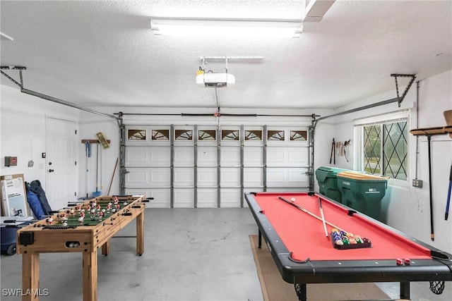 game room with a garage, a textured ceiling, and concrete flooring