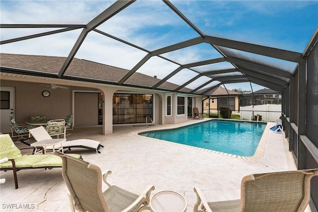 outdoor pool featuring a lanai and a patio area