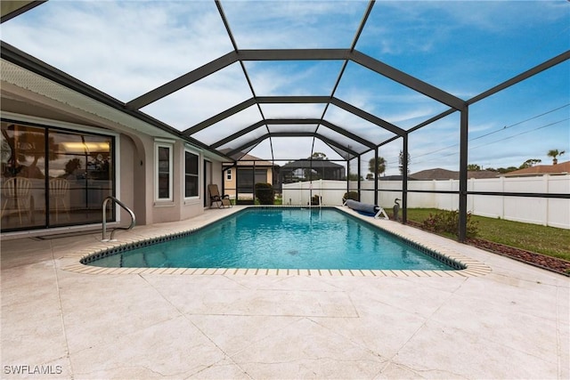 view of pool with a fenced in pool, glass enclosure, a patio area, and fence