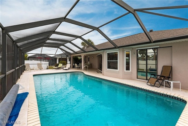 pool featuring a patio area and glass enclosure