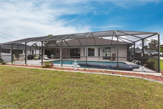 back of house featuring glass enclosure, a yard, an outdoor pool, and a patio