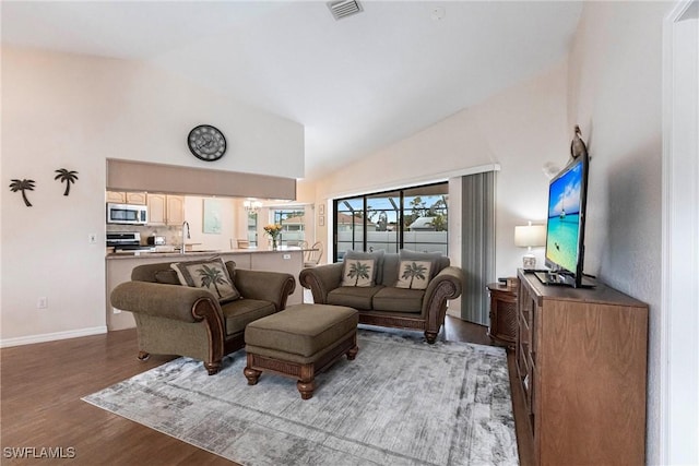 living area featuring dark wood-style floors, baseboards, visible vents, and high vaulted ceiling