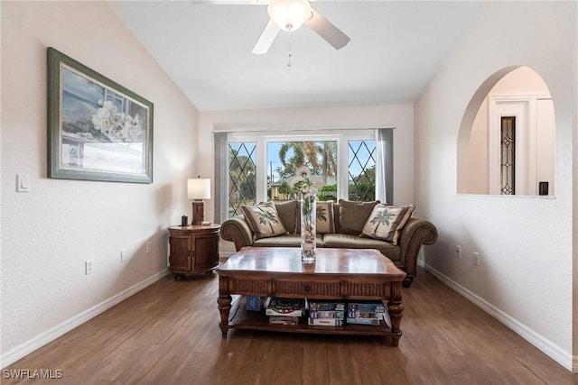 sitting room with ceiling fan, baseboards, vaulted ceiling, and wood finished floors