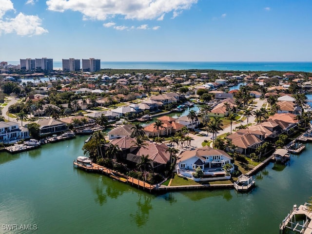 drone / aerial view with a water view, a residential view, and a city view