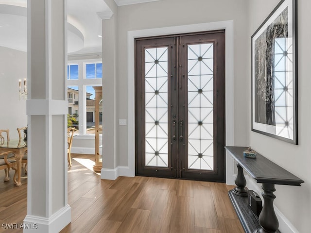 entryway featuring french doors, baseboards, and wood finished floors