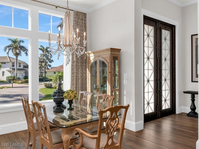 dining space with french doors, dark wood-type flooring, plenty of natural light, and a notable chandelier