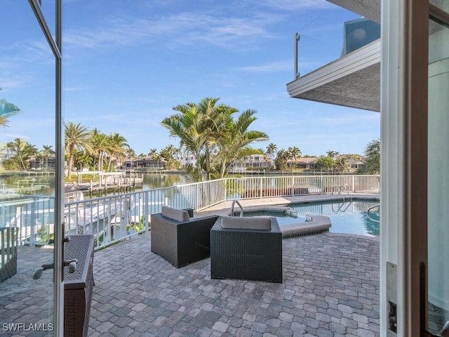 view of patio featuring a water view and a pool with connected hot tub