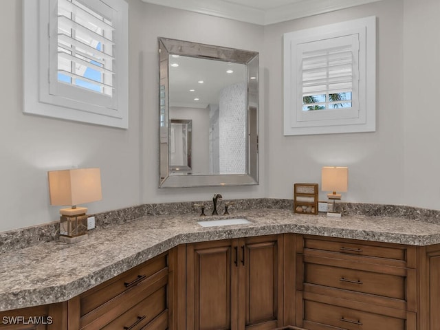 bathroom with crown molding and vanity