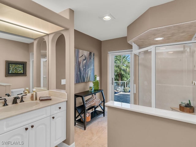 full bath with toilet, a shower stall, vanity, and recessed lighting