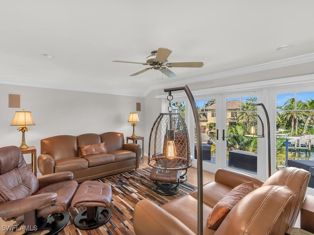 living room with french doors, ornamental molding, wood finished floors, and a ceiling fan