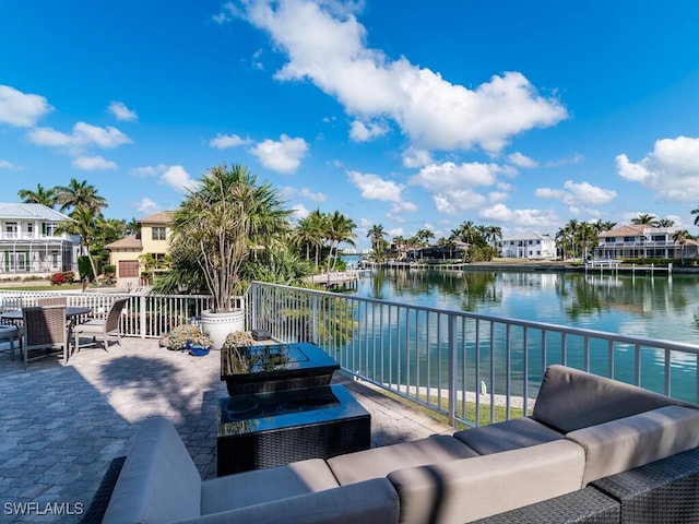 view of patio with a residential view, a water view, and outdoor lounge area