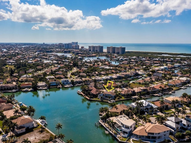 drone / aerial view featuring a water view and a city view