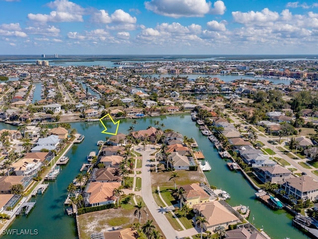 birds eye view of property with a residential view and a water view