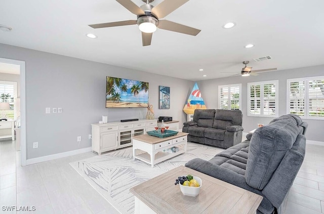 living room featuring baseboards, visible vents, and recessed lighting