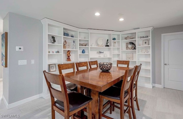 dining room with recessed lighting and baseboards