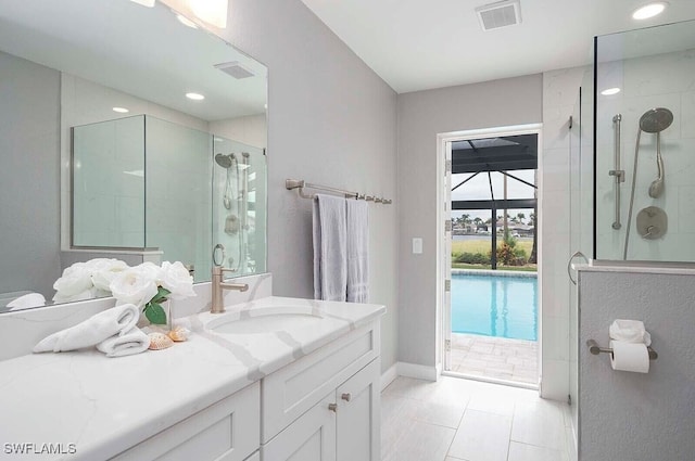 bathroom featuring a shower stall, visible vents, tile patterned flooring, and vanity