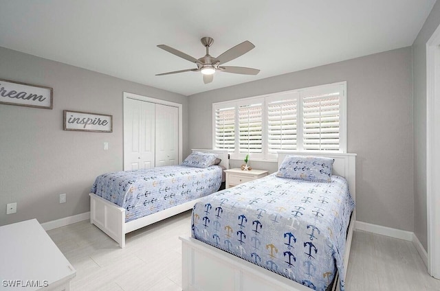 bedroom with ceiling fan, baseboards, and a closet