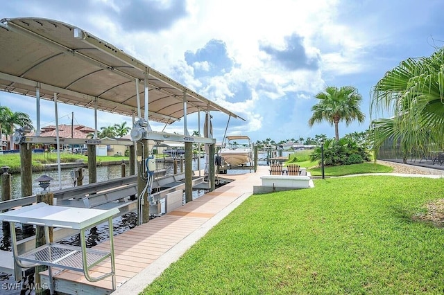 view of dock with a yard, a water view, and boat lift