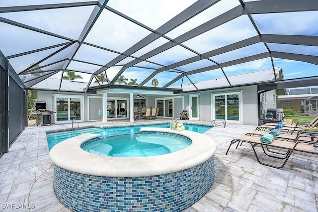 view of pool featuring area for grilling, a patio area, a lanai, and a pool with connected hot tub