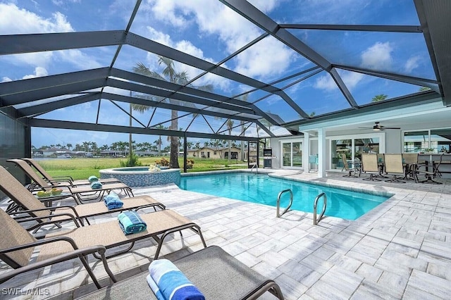 view of pool featuring a pool with connected hot tub, a lanai, a patio, and ceiling fan