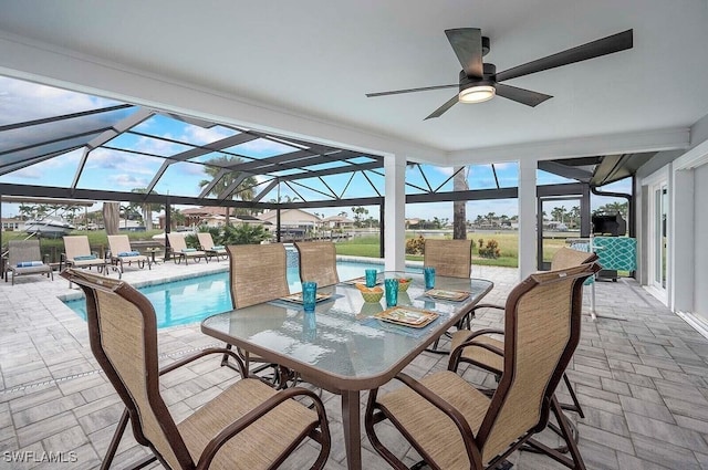 sunroom / solarium featuring ceiling fan