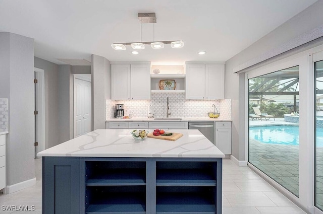 kitchen with dishwasher, a center island, light stone countertops, open shelves, and a sink