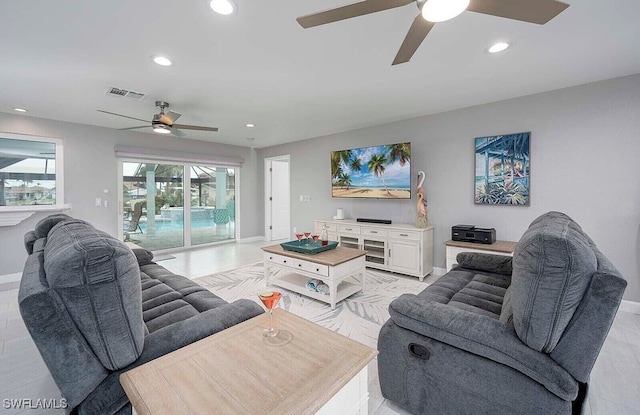 living area featuring baseboards, visible vents, and recessed lighting