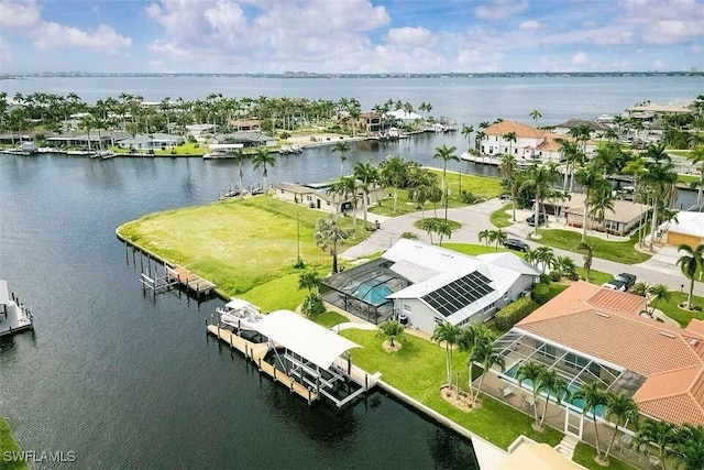 birds eye view of property with a water view and a residential view