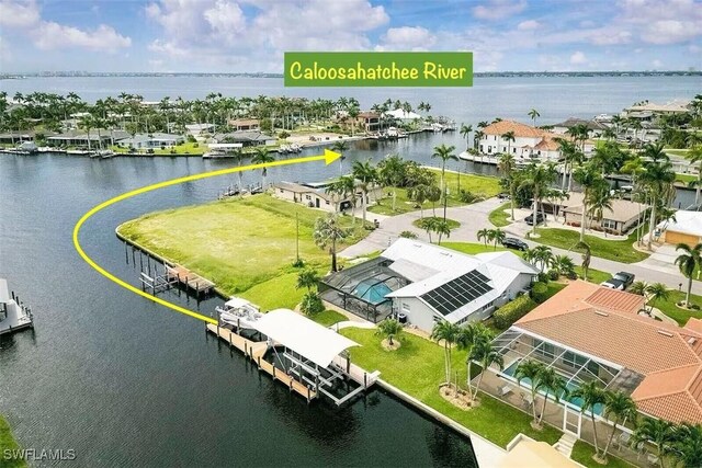 birds eye view of property featuring a water view and a residential view