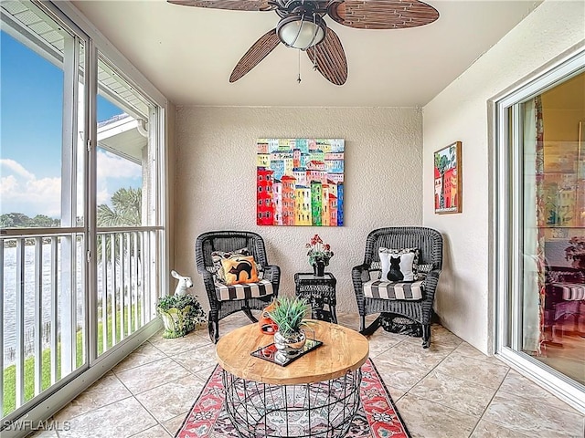 sunroom featuring plenty of natural light and a ceiling fan