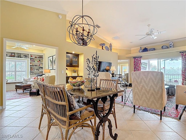 dining area with light tile patterned floors, built in shelves, crown molding, and ceiling fan with notable chandelier