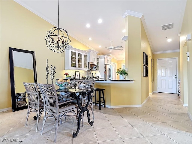 dining space with visible vents, crown molding, and light tile patterned floors