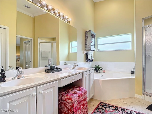 full bathroom with a stall shower, tile patterned flooring, visible vents, and a sink