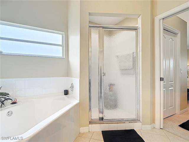 full bathroom featuring tile patterned flooring, connected bathroom, a shower stall, and a bath