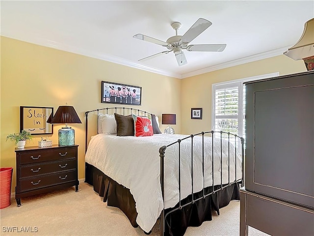 bedroom featuring light colored carpet, crown molding, and ceiling fan