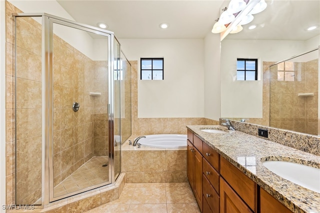 bathroom featuring a stall shower, tile patterned flooring, a sink, and a bath