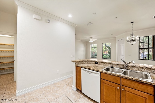 kitchen with white dishwasher, a sink, ornamental molding, brown cabinets, and plenty of natural light