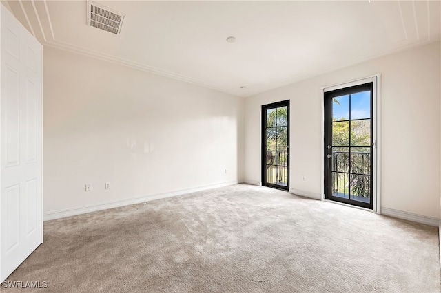 carpeted empty room with visible vents and baseboards