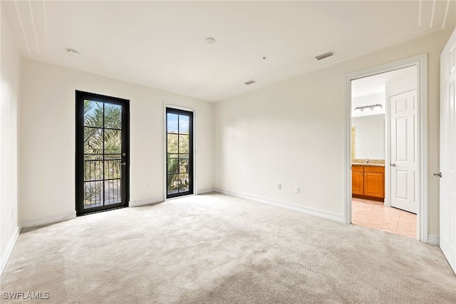 empty room with light carpet, visible vents, and baseboards