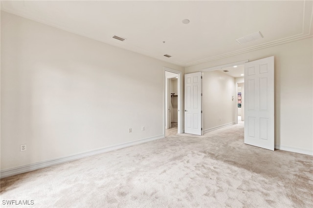 empty room with light carpet, visible vents, and baseboards