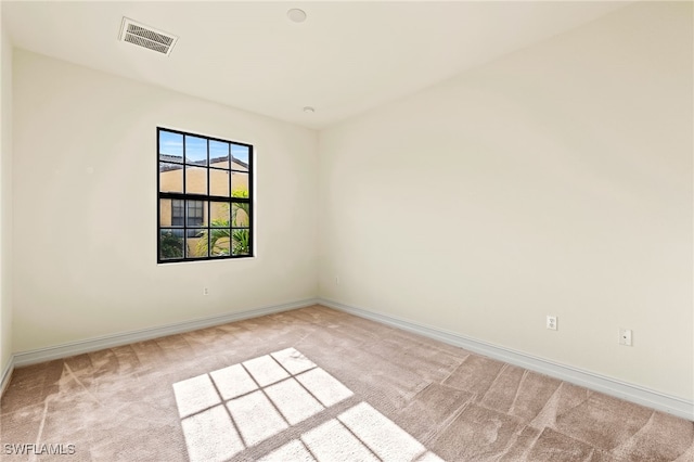 carpeted empty room with baseboards and visible vents