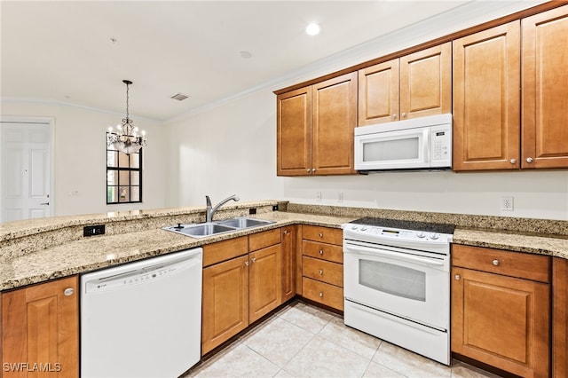 kitchen featuring light stone counters, crown molding, light tile patterned floors, a sink, and white appliances