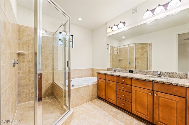 full bathroom featuring tile patterned flooring, a sink, a bath, and a shower stall