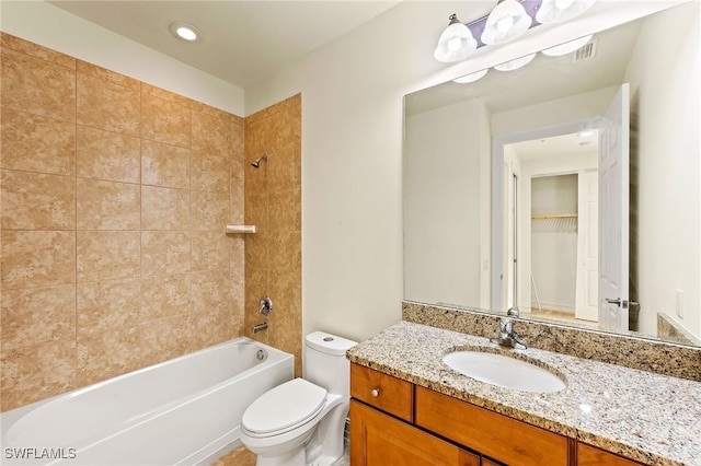 full bath with toilet, bathing tub / shower combination, visible vents, and vanity