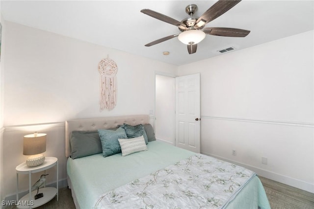 bedroom featuring ceiling fan, visible vents, and baseboards