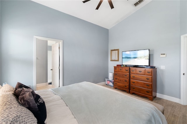 bedroom featuring visible vents, ceiling fan, high vaulted ceiling, light wood-type flooring, and baseboards