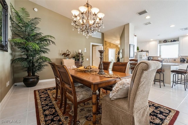 dining room featuring light tile patterned floors, baseboards, and visible vents