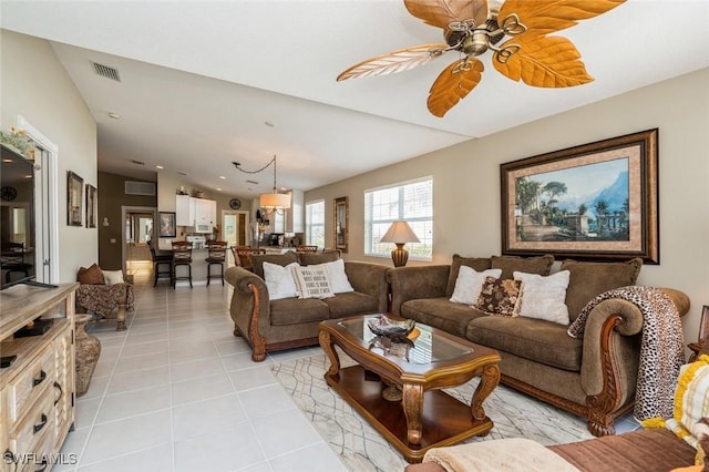 living area featuring a ceiling fan, visible vents, and light tile patterned flooring