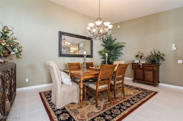 dining space with light tile patterned floors, baseboards, and an inviting chandelier